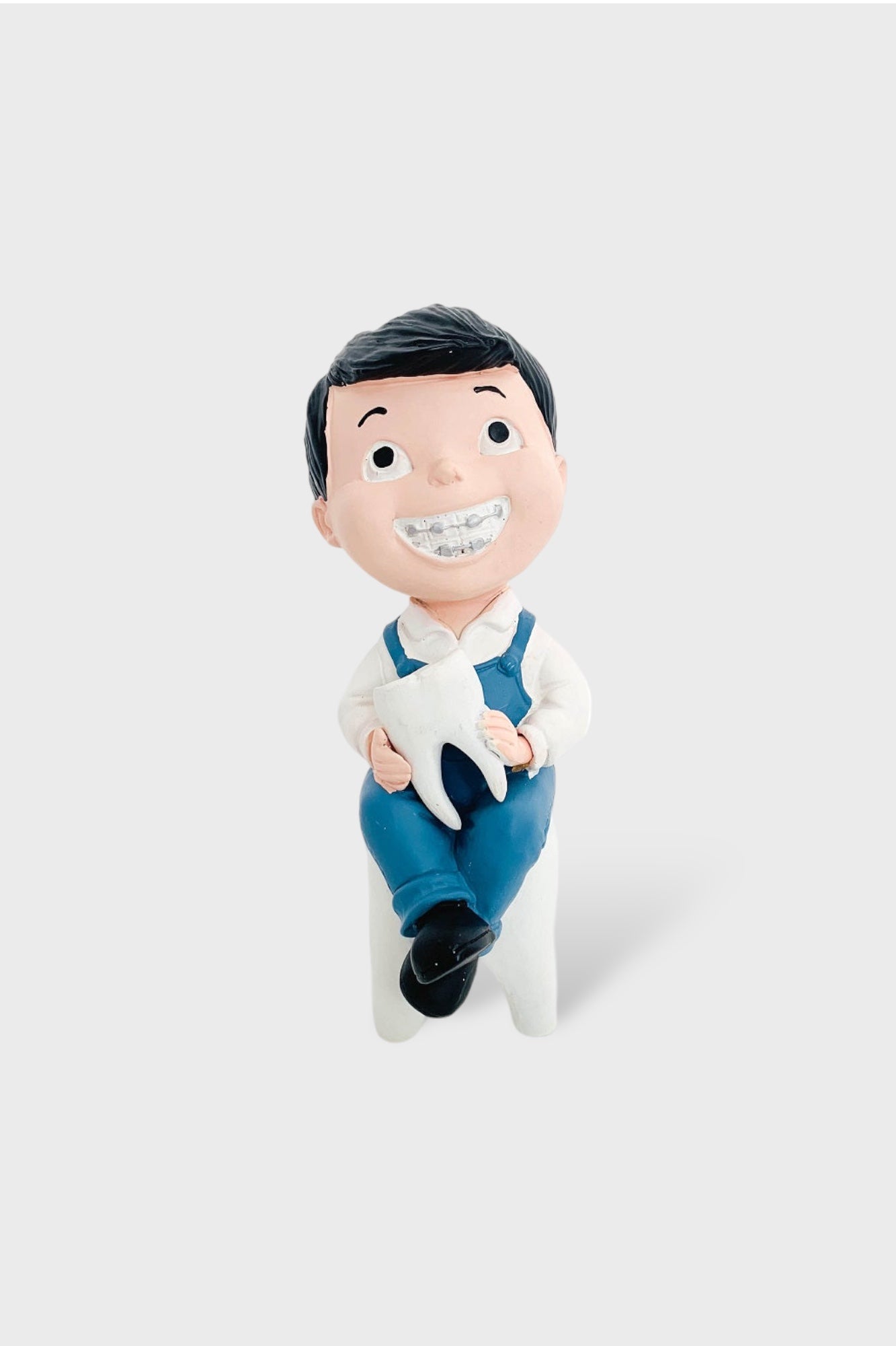 Boy With Tooth Figurine