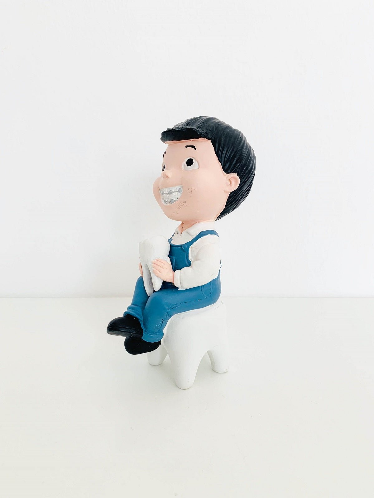 Boy With Tooth Figurine